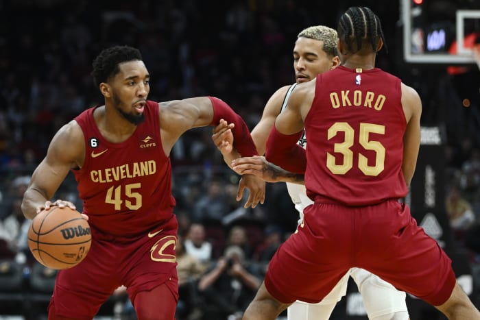 Feb 13, 2023; Cleveland, Ohio, USA; Cleveland Cavaliers guard Donovan Mitchell (45) drives to the basket as forward Isaac Okoro (35) sets a pick on San Antonio Spurs forward Jeremy Sochan (10) during the second half at Rocket Mortgage FieldHouse. Mandatory Credit: Ken Blaze-USA TODAY Sports